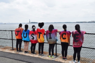 children with shirts spelling "Justice"